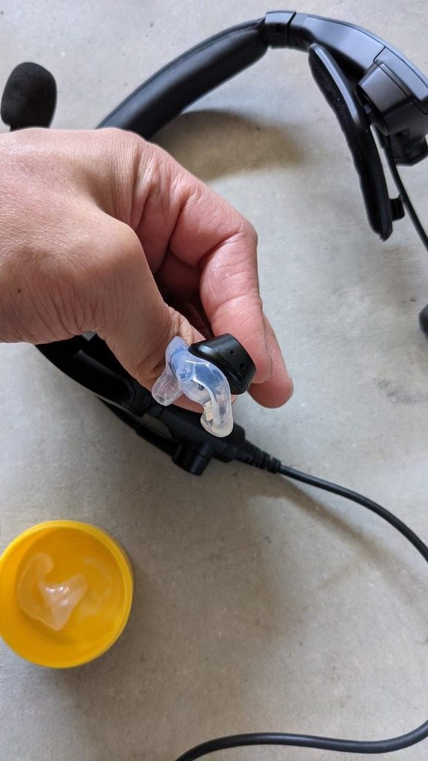 Custom Big Ear adapter on a Bose ProFlight earpiece, held in hand