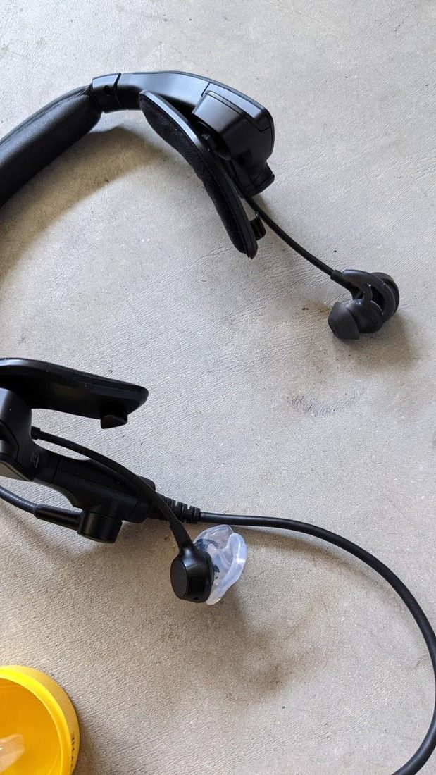 A Bose ProFlight with the stock tip beside one with a custom Big Ear adapter