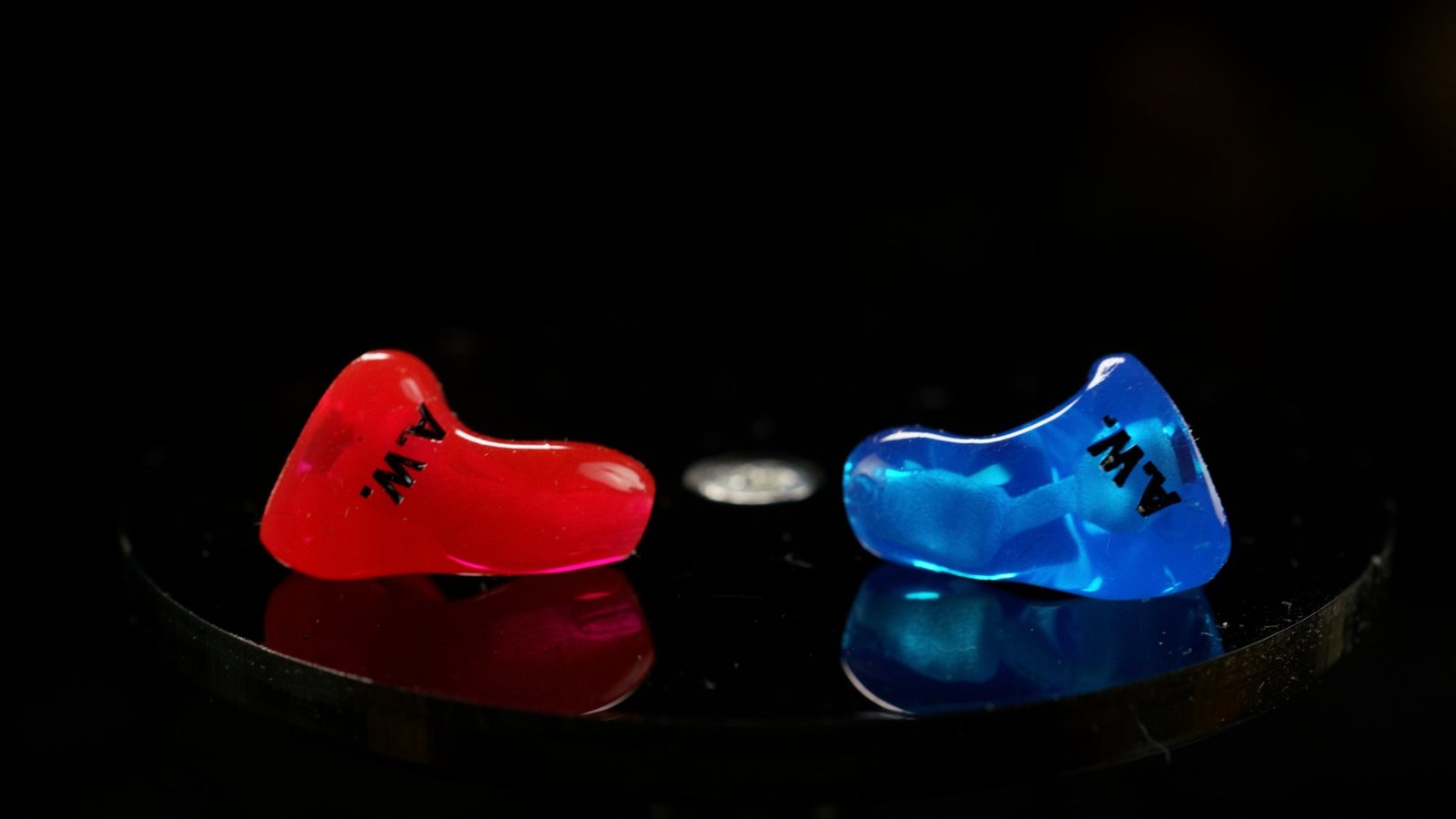 Custom CEP aviation adapters, one red and one blue, on a studio pedestal