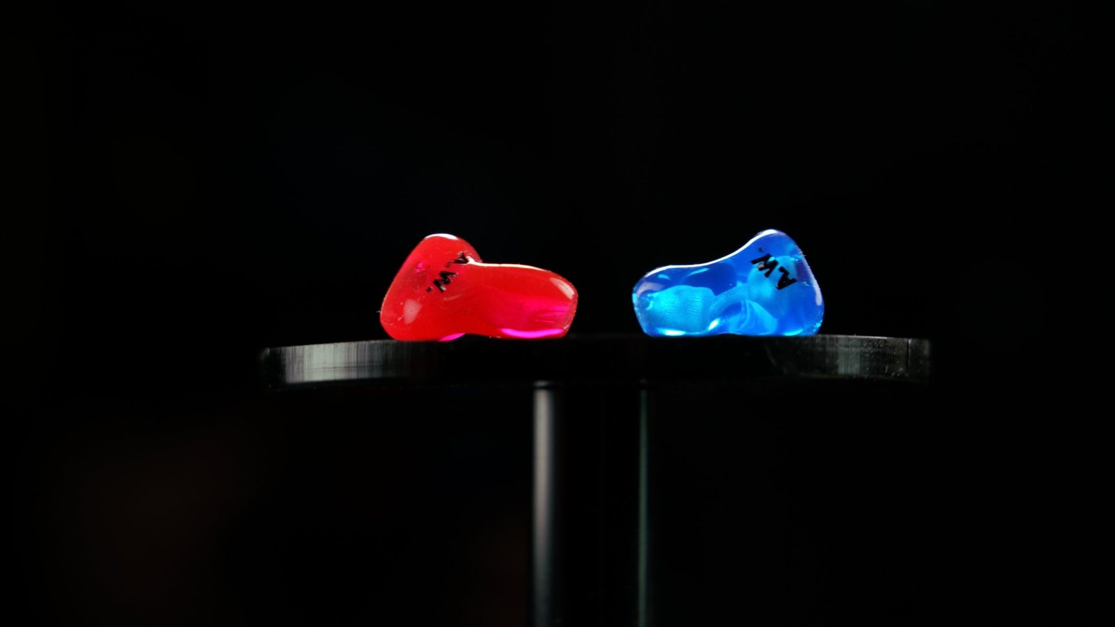 Red and blue custom CEP aviation adapters standing on a studio pedestal