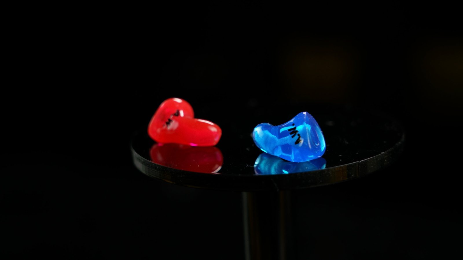 Red and blue custom CEP aviation adapters on a reflective studio surface