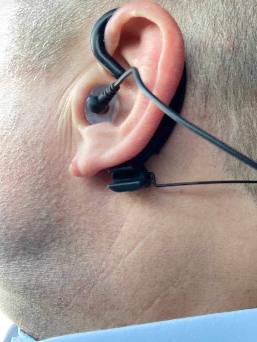 Pilot wearing a Clarity Aloft headset with a custom Big Ear adapter seated in the ear in the cockpit
