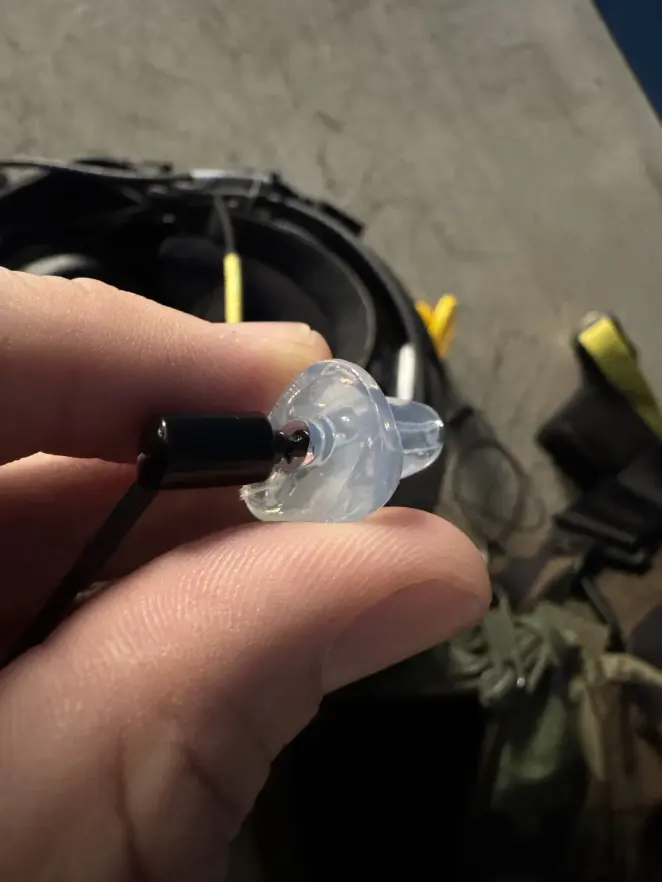 A clear custom CEP adapter held in the field