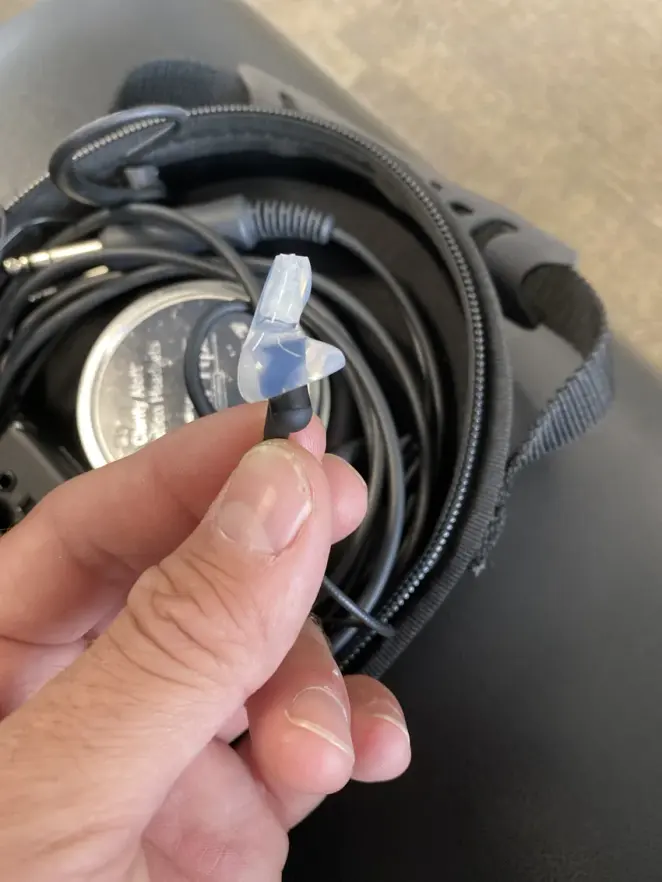 A clear custom Clarity Aloft adapter with the tube tip, held over the Clarity Aloft case