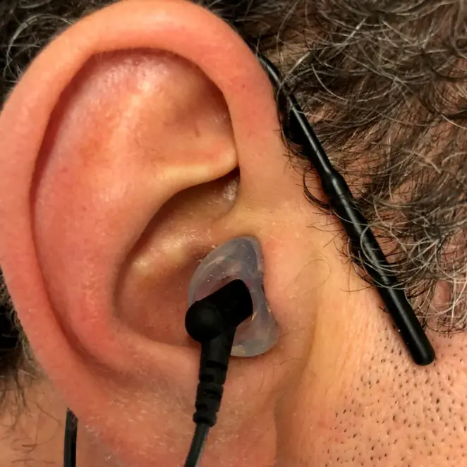 A custom Clarity Aloft adapter worn in the ear