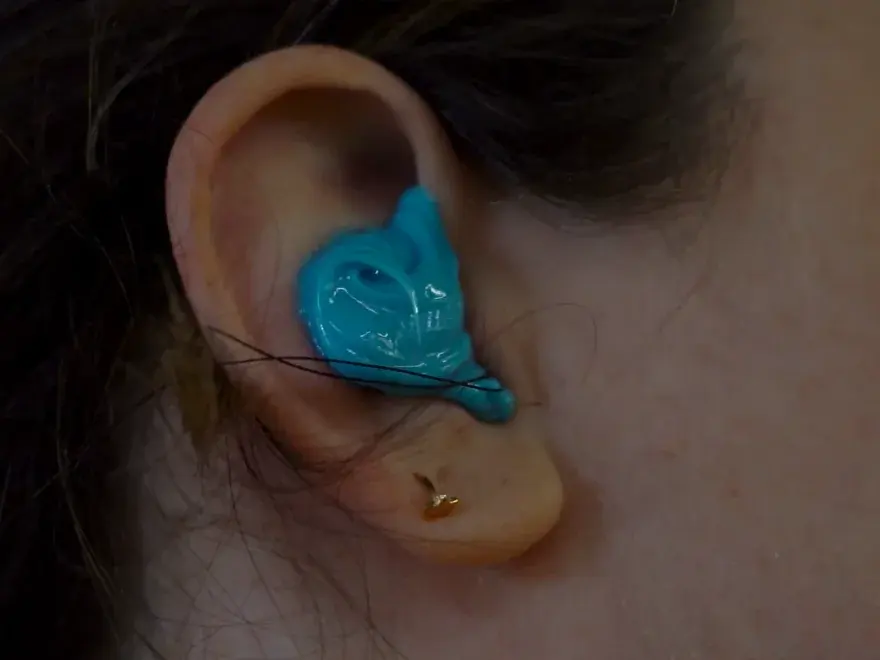 A real Big Ear ear impression — blue molding material capturing the exact shape of the ear