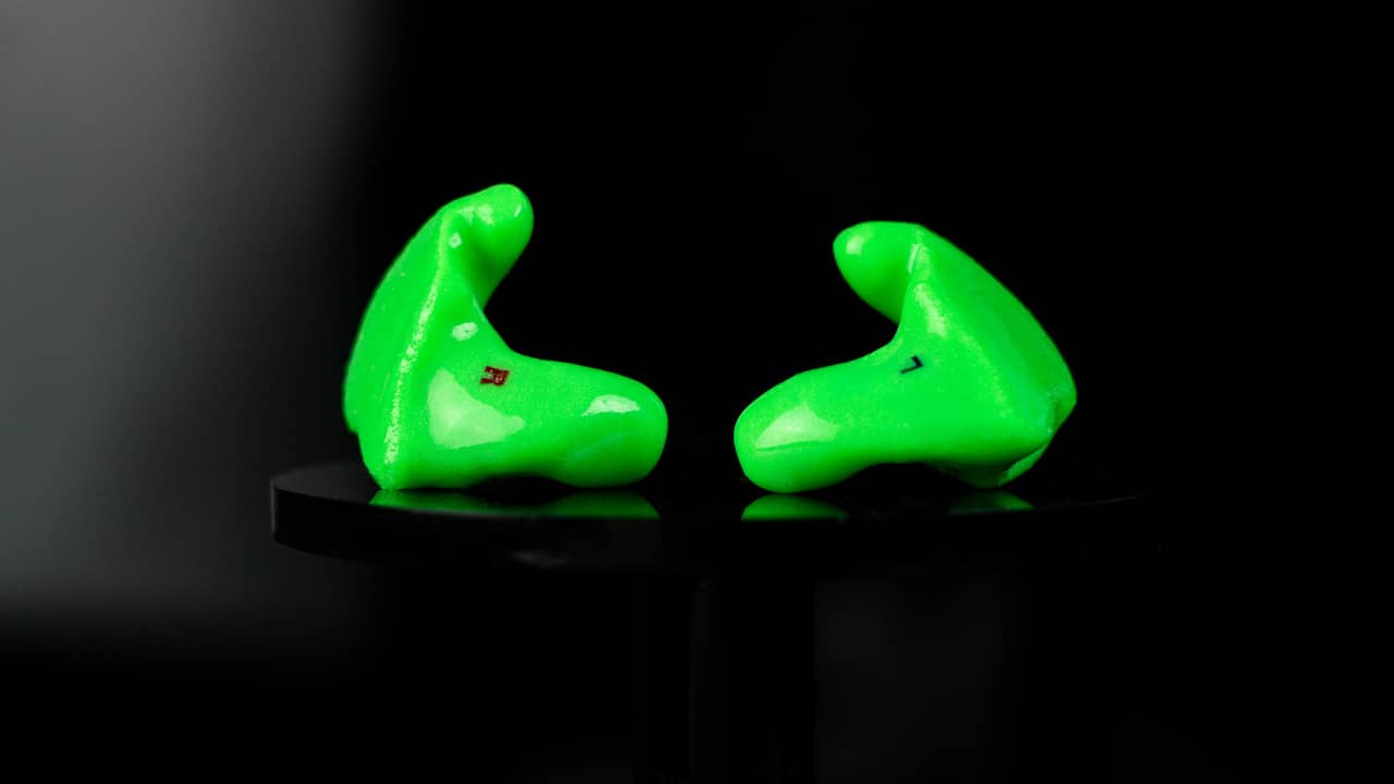Big Ear custom earplugs in solid green, left and right pair