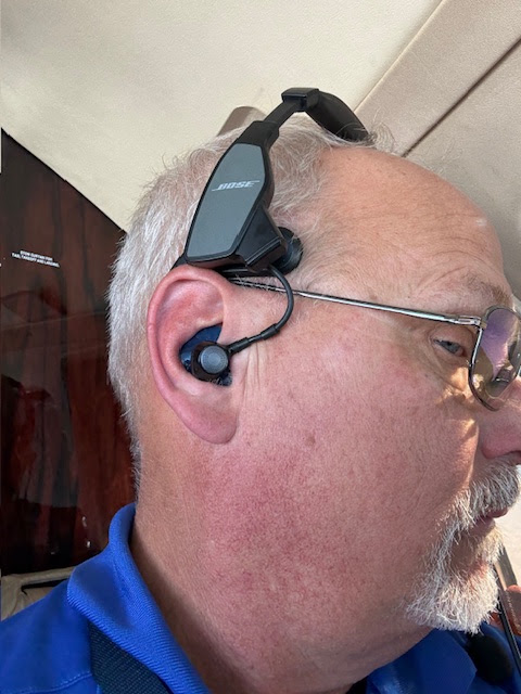 Pilot wearing a Bose ProFlight with a custom Big Ear adapter